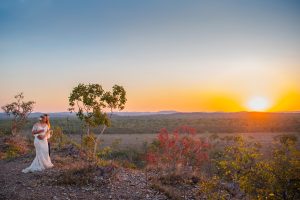 A newly married couple posing nest to a tree with the sunset in the background, located in the country side of Mudgee. Photo taken by Kate Freestone photographer